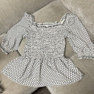 Black and white poca dot smocked top.